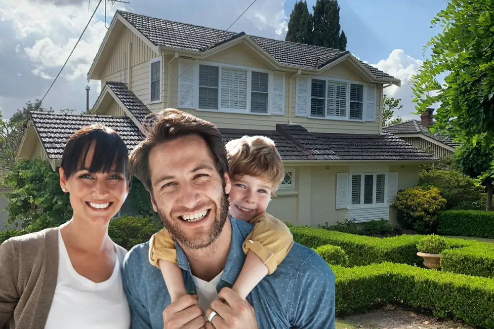 Smiling family outside their home